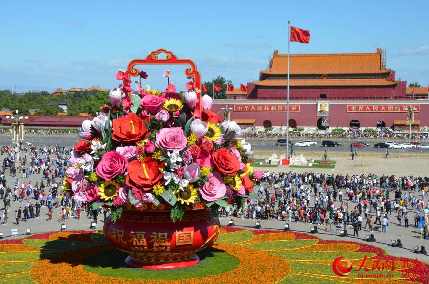 今天上午，天安门广场中心布置的“祝福祖国”巨型花篮组装完成，展现在游客面前。人民网尹星云 摄