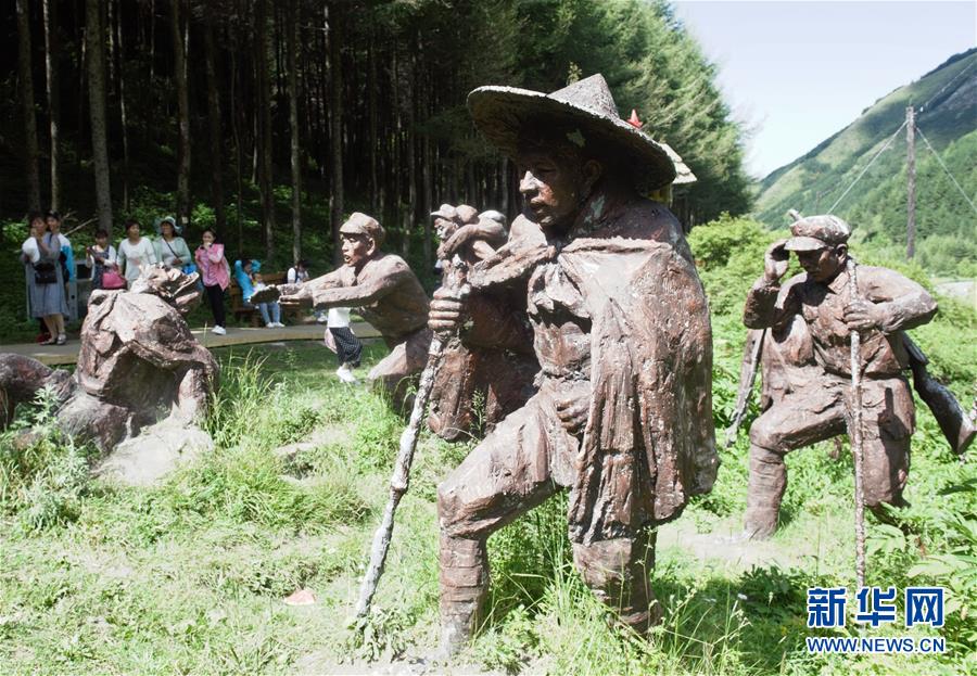 8月12日，游人经过六盘山“红军小道”上的”过草地“景观。  新华社记者 罗晓光 摄