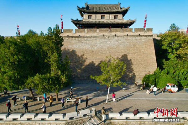 11月24日，陕西西安，冬日暖阳下的城墙根，市民们聚集在此休闲娱乐。（无人机照片）中新社记者 张远 摄